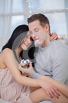 Couple in love eating sweet cake