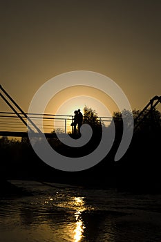 Couple in love is embracing on the bridge