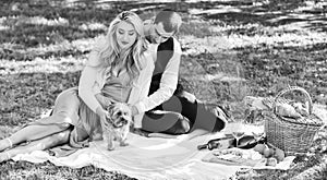 Couple in love enjoy picnic time. Spring date. Playful couple having picnic in park. Couple cuddling relaxing at green