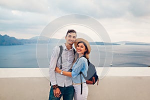 Couple in love enjoying honeymoon on Santorini island Greece at sunset in Oia. Summer vacation traveling