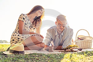 Couple in love enjoying picnic time and food outdoors