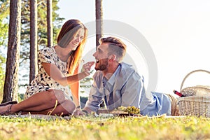 Couple in love enjoying picnic time and food outdoors