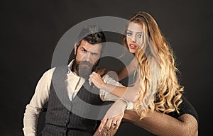 Couple in love. Fashionable woman posing. Bearded man and woman with long curly hair.