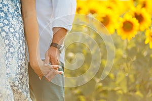 Couple in love in the field of romantic sunflowers