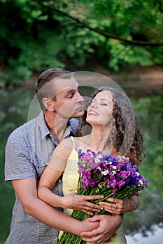Couple in love flirting, happy woman with flowers