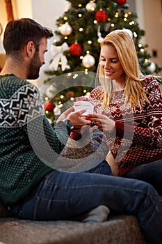 Couple in love with gift for Christmas eve