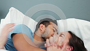 Couple, love and happy with a man and woman laughing, kissing and drinking coffee together in their home. A montage of
