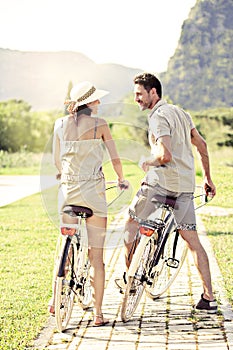 Couple in love have a ride with bicycles in the nature