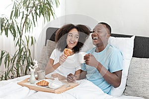 Couple in love having breakfast in bed during honeymoon in covid-19 and enjoying rest