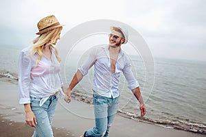 Couple in love having fun dating on beach.