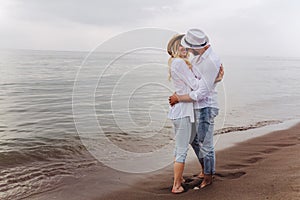 Couple in love having fun dating on beach