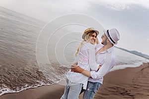 Couple in love having fun dating on beach