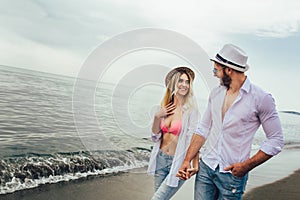 Couple in love having fun dating on beach