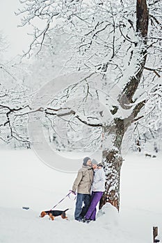 Couple in love having fun in the snow throwing snowballs.