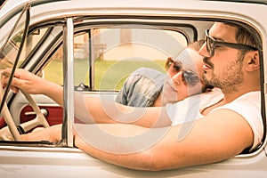 Couple in love having a rest during honeymoon vintage car trip photo