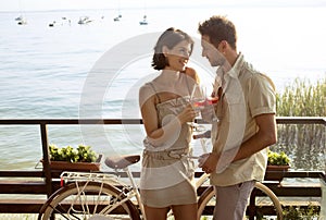 Couple in love having spritz time with Garda lake view photo
