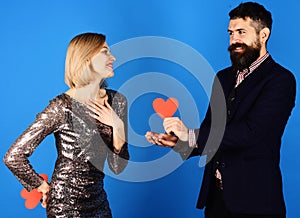 Couple in love holds hearts on blue background