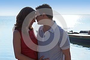 Couple in love hug in suset on sea