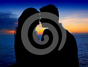 Couple in love hug in suset on sea