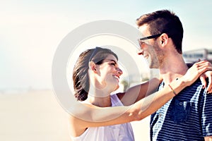 Couple in love hugging affectionately in front of the sea