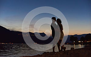 Couple in love hugging on the beach at night.