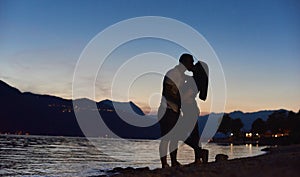 Couple in love hugging on the beach at night.
