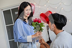 Couple in love hugging in the bedroom with rose and gift Valentine's Day concept