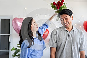 Couple in love hugging in the bedroom with rose and gift Valentine's Day concept