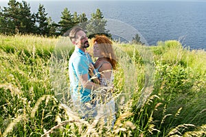 couple in love hugging in big green grass. Couple in love passionately hugging. Long-awaited meeting of the two lovers in grass