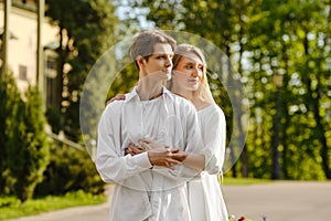 Couple in love hugging and looking to the side