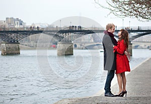 Couple in love hugging near Pont des Arts in Paris photo