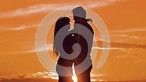 Couple in love hugging at sunset sunlight silhouette. family love concept love. Couple man and girl silhouettes of love