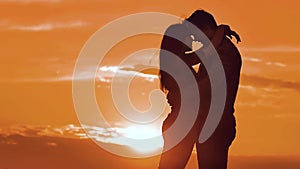 Couple in love hugging at sunset sunlight silhouette. family love concept love. Couple man and girl silhouettes of love