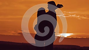 Couple in love hugging at sunset sunlight silhouette. family love concept love. Couple man and girl silhouettes of love