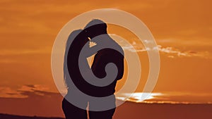 Couple in love hugging at sunset sunlight silhouette. family love concept love. Couple man and girl silhouettes of love