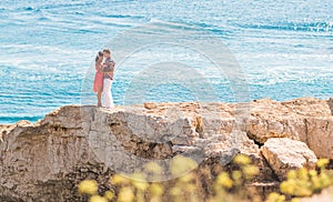 Couple in love hugging on tropical beach with a turquoise water background