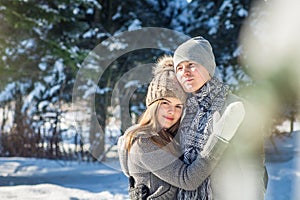 Couple in love hugs in winter forest