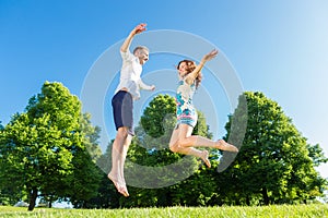 Couple in love jumping on park