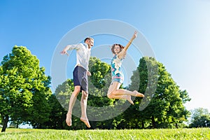 Couple in love jumping on park