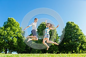 Couple in love jumping on park