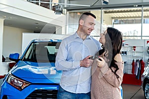 Couple in love with keys from new car