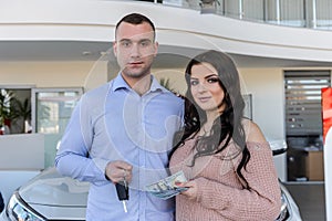 Couple in love with keys from new car