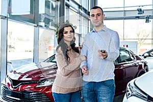 Couple in love with keys from new car