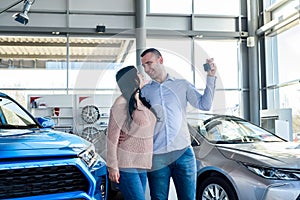 Couple in love with keys from new car