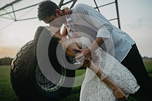 Couple in love kisses under water drops from agricultural sprayer