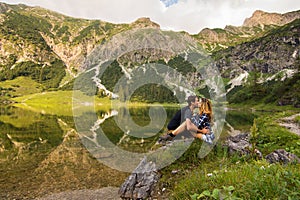 Couple in love kissing in front of mountain lake from Bavaria , Germany. Pretty couple in nature