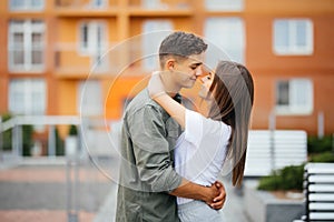 Couple in love kissing laughing having fun. Dating young couple embracing on date.