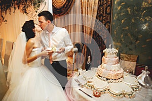Couple in love kissing near wedding cake photo