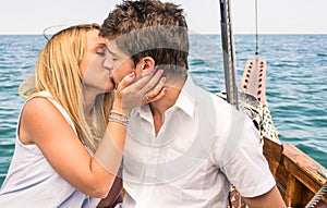 Couple in Love kissing on a sailing Boat in the middle of the Sea