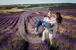 Couple in love on lavender fields. Boy and girl in the flower fields